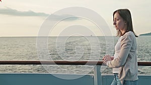 Young woman on cruise ship at sunrise