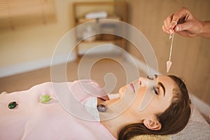 Young woman at crystal healing session