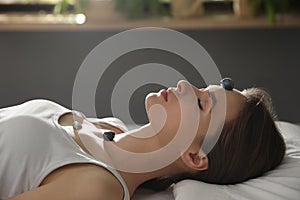 Young woman during crystal healing session in room