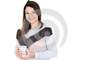 Young woman with cup of coffee looks camera with blank copy space