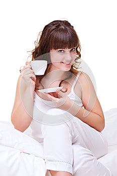 Young woman with cup of coffee in morning