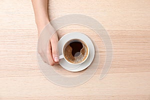 Young woman with cup of delicious hot coffee