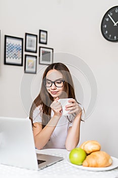 Young woman with cup of tea having breakfast in the morning. Healthy Eating, Breakfast, Women.