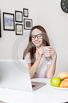 Young woman with cup of tea having breakfast in the morning. Healthy Eating, Breakfast, Women.