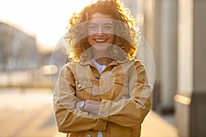 Young woman with curly hair in the city