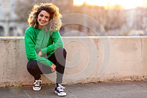 Young woman with curly hair in the city