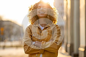 Young woman with curly hair in the city