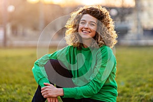 Young woman with curly hair in the city