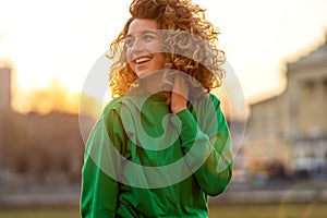 Young woman with curly hair in the city