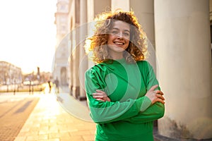 Young woman with curly hair in the city