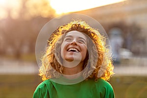 Young woman with curly hair in the city