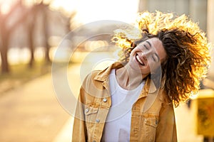 Young woman with curly hair in the city