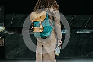 Young woman curly red head girl traveller with backpack and map in subway station