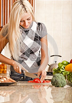 Young Woman Cutting Tomato