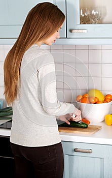 Young woman cutting vegetables