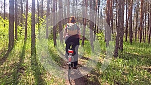 Young woman cycling in the forest