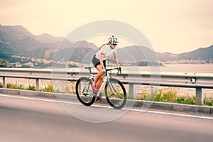 Young Woman Cyclist Riding Bike on the Mountain Road. Adventure, Healthy Lifestyle, Sport
