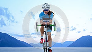 Young Woman Cyclist Riding Road Bike in the Beautiful Mountains. Adventure, Healthy Lifestyle, Sport