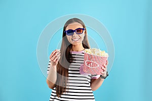 Young woman with 3D glasses and tasty popcorn