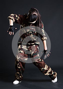 Young woman dancing in camouflage