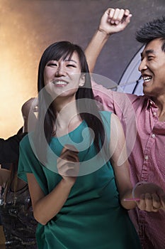 A young woman dancing with friends in a nightclub