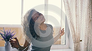 Young woman dancing with a garland in her hair. Slow motion. Winter Holidays Concept