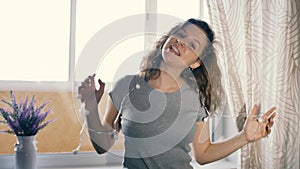 Young woman dancing with a garland in her hair. Slow motion. Winter Holidays Concept