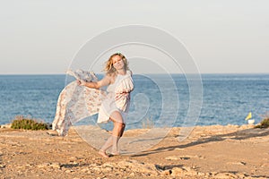 Young woman dancing with long scarf