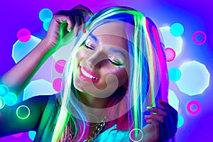 Young woman dancing in neon light