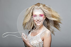 Young woman dancing to music on her headphones
