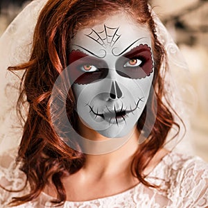 Young woman in day of the dead mask