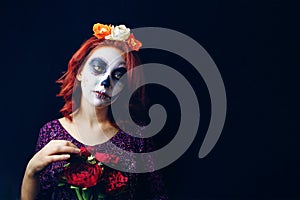 A young woman in day of the dead mask skull face art.