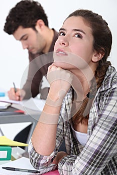 Young woman daydreaming in class