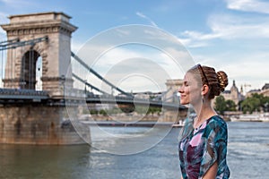 Young woman daydreaming at Szechenyi Chain Bridge at Budapest