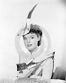 Young woman decorated with pen and quill