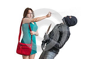 Young woman is defending with pepper spray against armed thief with knife.