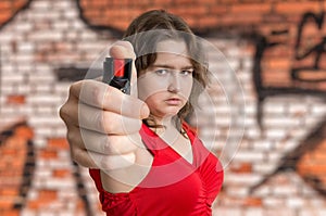 Young woman is defending with pepper spray. Self defense concept photo