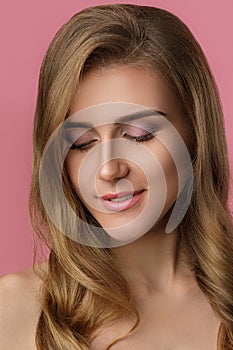 Young woman with delicate pink make-up