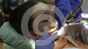 Young woman in dental clinic. Teeth cleaning.