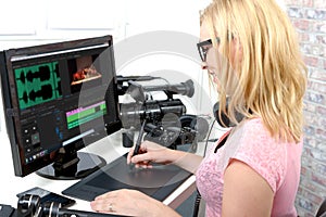 Young woman designer using computer for the video editing