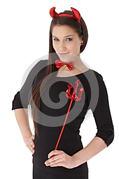 Young woman in devil costume smiling