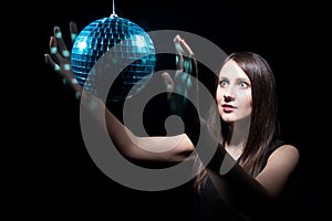 Young woman with disco ball