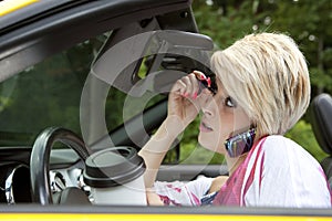 Young woman distracted while driving photo