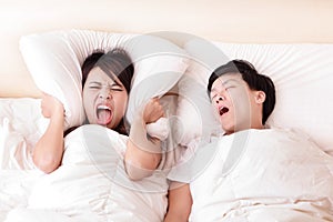 Young woman disturbed by the snores of her husband