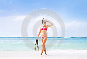 Young woman with a diving mask on the beach