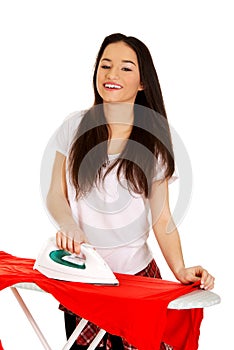 Young woman do the ironing.