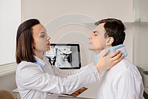 Young woman doctor apply traumatological collar