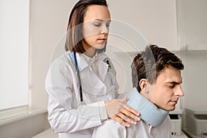 Young woman doctor apply traumatological collar