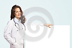 Young woman doctor with a blank banner
