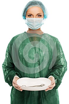 Young woman doctor in cap and face mask